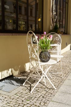two chairs and a table in front of a store for decoration articles in a shopping street in Wittenberg in Germany