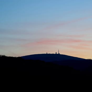 View of Brocken peak in Harz National Park in Germany from Wernigerode town after sunset