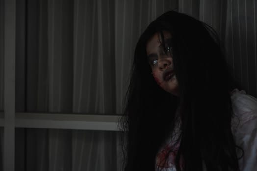 Horror evil woman ghost creepy in a dark room at house. The female devil is scary she haunted at the abandoned building, Happy Halloween day concept.