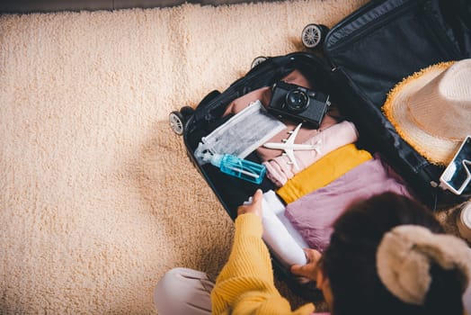 Preparing for travel in new normal. Woman packing clothes in luggage for new journey, Preparation travel suitcase at home, Travel vacation traveling after quarantine coronavirus pandemic concept
