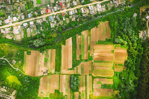 Aerial View Of Vegetable Gardens In Small Town Or Village. Skyline In Summer Evening. Village Garden Beds In Bird's-eye View.
