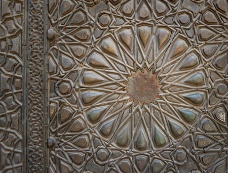 Ornaments of the bronze-plate ornate door of Sultan Barquq mosque, ancient public historic mosque in Old Cairo, Egypt