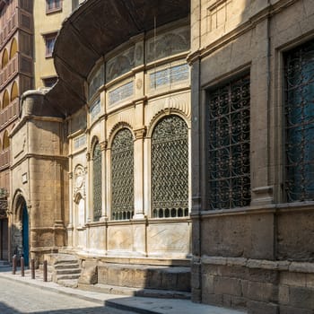 Moez Street with facade of Ottoman era historic Soliman Agha El Silahdar complex building, Old Cairo, Egypt