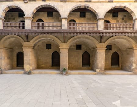 Facade of historic Wikala of Bazaraa building, with vaulted arcades and oriental wooden oriel windows, suited in Tombakshia street, Gamalia district, Medieval Cairo, Egypt