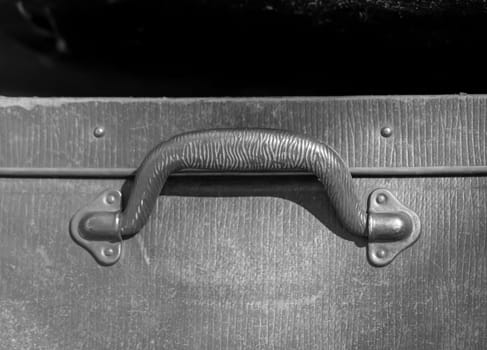 A close-up, detail shot of an old leather suitcase.