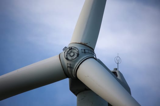 Close-up of the hub of a wind turbine. Blade and hub of a wind turbine.