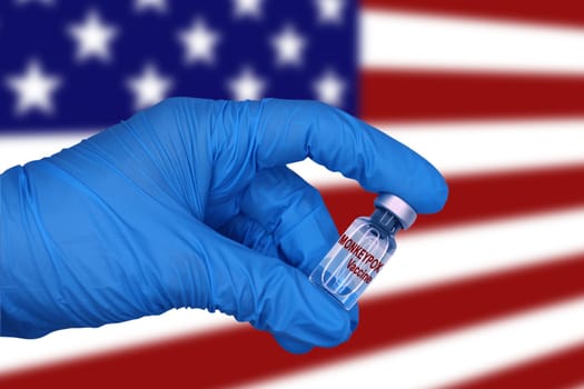 Monkeypox vaccine close-up on blurred background of united states of america flag