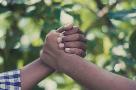 Friends Shaking Hands. Handshake man. Friendly handshake of two men. Close up of men greeting with handshake. Friends handshaking of two hands.