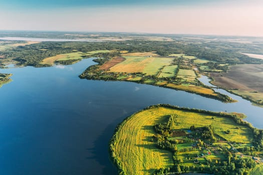 Lyepyel District, Vitebsk Region, Belarus. Aerial View Of Residential Area With Houses In Countryside. Morning Fog Above Lepel Lake And Town Skyline.