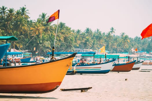 Canacona, Goa, India. Fishing Boats With Flags Parked On Famous Palolem Beach In Summer Sunny Day.
