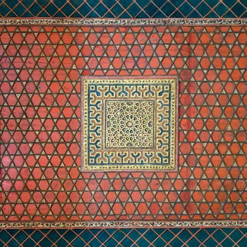 Part of wooden ceiling decorated with floral patterns painted in red and blue at Mamluk era Prince Taz Palace situated on the intersection of Saliba Street and Suyufiyya Street, Medieval Cairo, Egypt