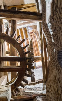 From below shot of aged water mill turning inside weathered mill building at Amir Taz palace, Medieval Cairo, Egypt