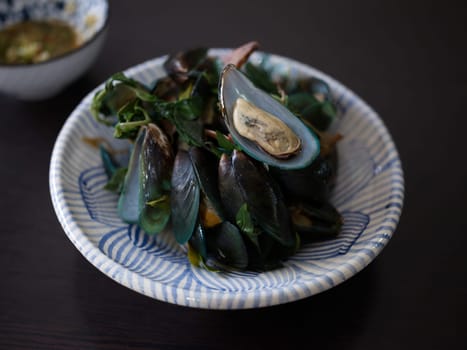 Thai Food steamed mussels with basil . Eaten with spicy sauce.