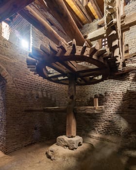 Aged water mill turning inside weathered mill building at Amir Taz palace, Medieval Cairo, Egypt