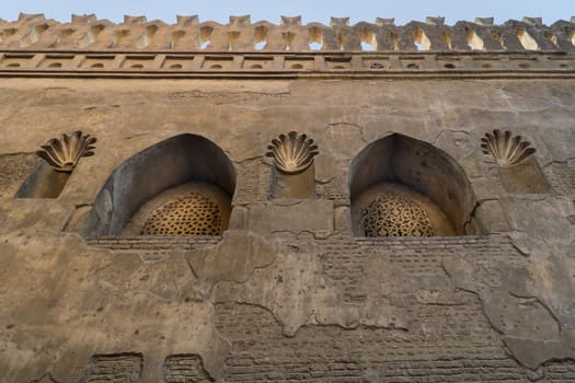 Two perforated arched stucco window decorated with floral patterns, one of the traditions of the Mamluk era, Outer wall of Mosque of Ibn Tulun, Sayyida Zaynab district, Medieval Cairo, Egypt