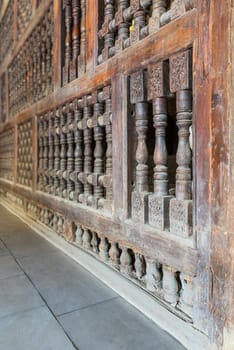 Angle view of interleaved wooden ornate wall - Mashrabiya - at abandoned building