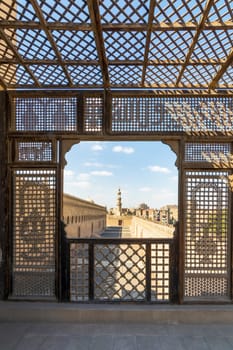 Passage surrounding the Mosque of Ibn Tulun framed by interleaved wooden perforated wall - Mashrabiya - Medieval Cairo, Egypt