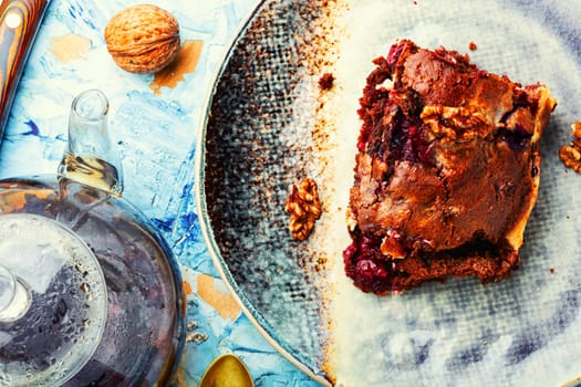 Piece of pie with chocolate, cherries and nuts. Sweet marble cake. Chocolate cupcake