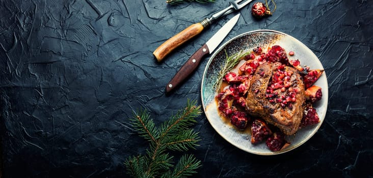 Piece of meat fried with pomegranate in baking dish