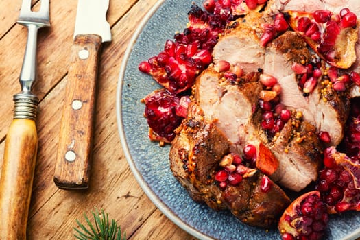 Piece of meat fried with pomegranate in baking dish