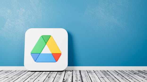 Google Drive App Logo 3D Symbol Shape on Wooden Floor Against Blue Wall with Copy Space 3D Render Illustration