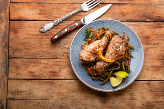 Roasted chicken with vegetable garnish and spices. Braised spicy chicken legs.