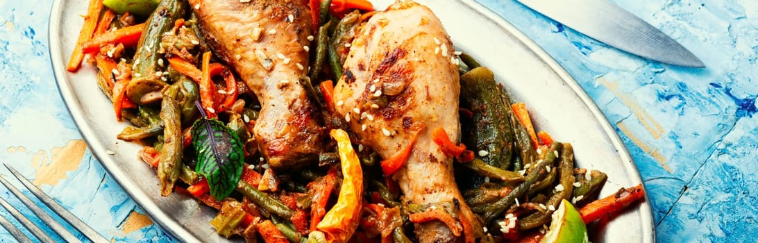 Roasted chicken with vegetable garnish and spices. Braised spicy chicken legs.