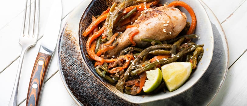 Roasted chicken with vegetable garnish and spices. Braised spicy chicken legs.