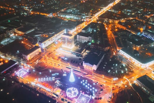 Gomel, Belarus. Main Christmas Tree And Festive Illumination On Lenin Square In Homel. New Year In Belarus. Aerial Night View.