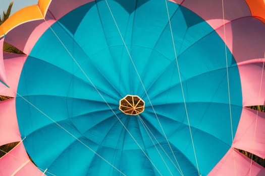 Close Multi-colored Parachute For Parasailing On Background Of Blue Sky.