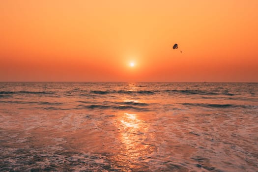 Sunset Sun Above Sea. Natural Sunrise Sky Warm Colors Over Ripple Sea. Ocean Water Foam Washing Sandy Beach At Sunset.