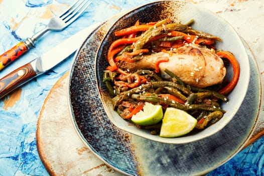 Roasted chicken with vegetable garnish and spices. Braised spicy chicken legs.