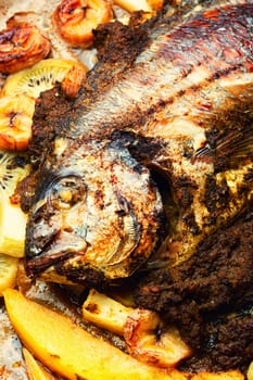 Tasty gilthead or dorado baked with pineapple, mango, kiwi and banana.