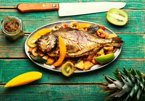 Tasty gilthead or dorado baked with pineapple, mango, kiwi and banana.