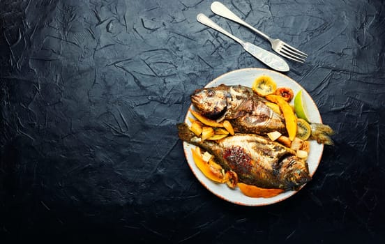 Tasty gilthead or dorado baked with pineapple, mango, kiwi and banana.