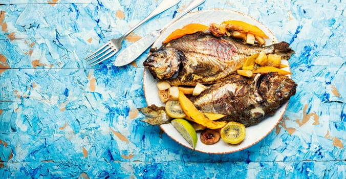 Tasty gilthead or dorado baked with pineapple, mango, kiwi and banana.