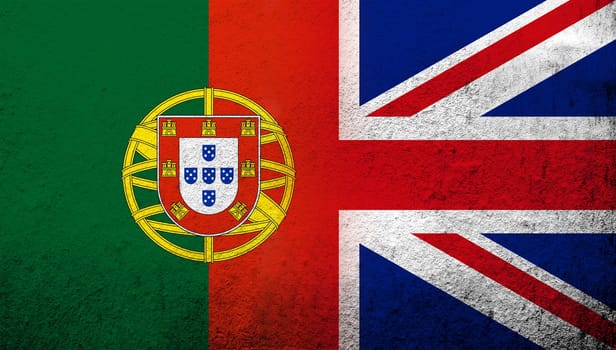 National flag of United Kingdom (Great Britain) Union Jack with Portugal National flag. Grunge background