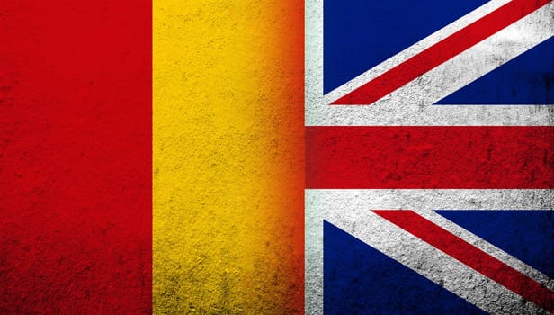 National flag of United Kingdom (Great Britain) Union Jack with The Republic of Guinea National flag. Grunge background
