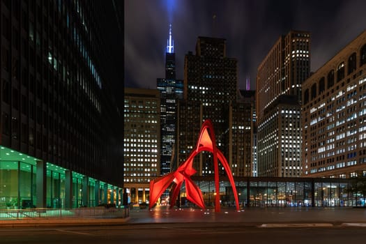 Chicago, Illinois / USA : October 13, 2018 Calder's Flamingo sculpture in the middle of the vibrant public place, Federal Plaza, in Chicago, enclosed by high-rise office buildings - Image