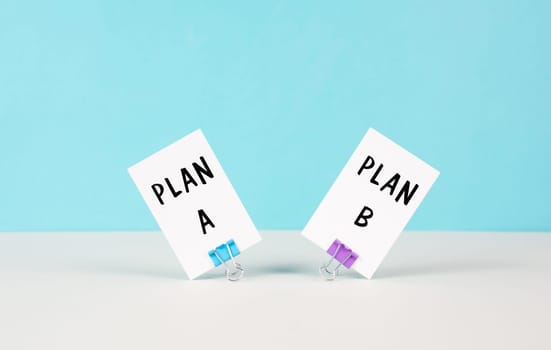 Plan A and B standing on paper, brainstorming for possibilities, making a decision