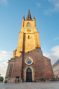 Tower of Riddarholmen Church, located in the island of Riddarholmshamnen, old city, Gamla stan. before sunset in a summer day, Stockholm, Sweden