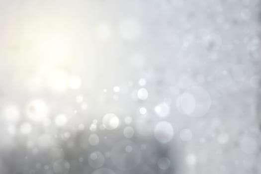 Abstract festive gradient light gray silver turquoise bokeh background texture with white bokeh lights. Beautiful backdrop with space for christmas, invitation or other holidays.
