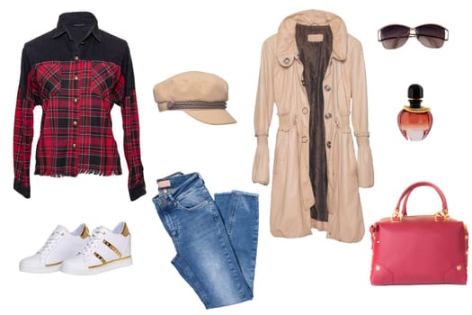 Collage woman clothes. Set of a stylish and trendy women coat, a blouse or shirt, white shoes, a handbag, a jeans and other accessories isolated on a white background. Latest fashion trends.