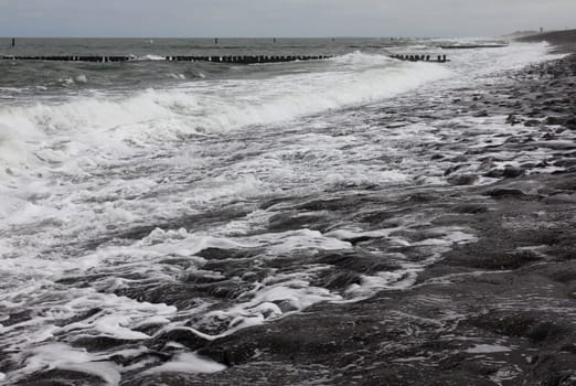 a strong waves breaking on the shore protection