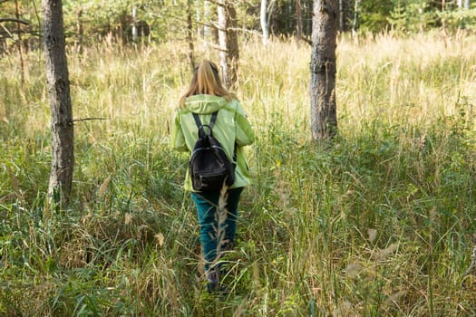 Woman play Geocaching. Walk in deep forest.