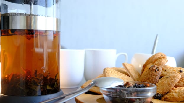 Jar with tea drink man hand filtering tea in glass