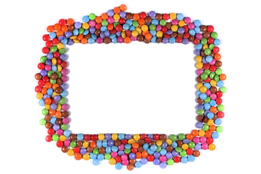 A Frame border of multi coloured halloween candy sweets on white