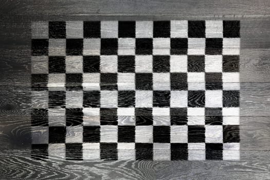 A Chequered flag on rustic old wood surface background
