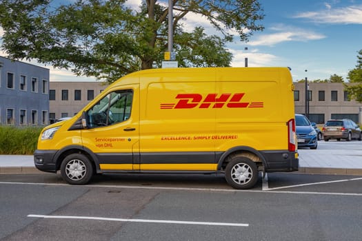 WETZLAR, GERMANY - 2021-10-01: DHL Logo on a yellow DHL Truck. DHL is owned by the German postal service Deutsche Post.
