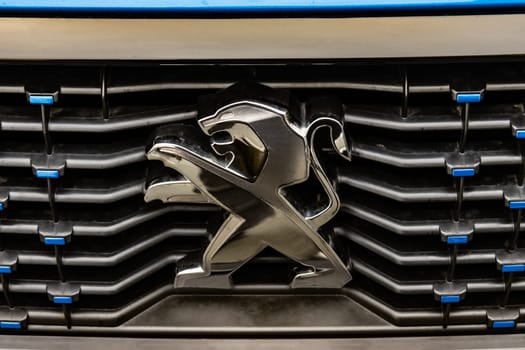 WETZLAR, GERMANY 2022-04-23: Peugeot logo closeup on a car grill. Peugeot as car manufacturer was founded at 1882.